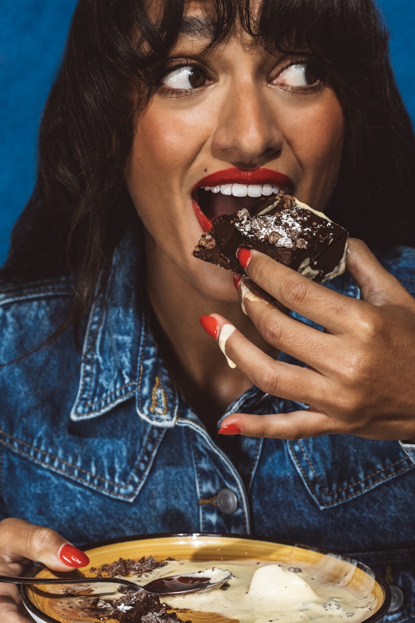 a woman eating a piece of food