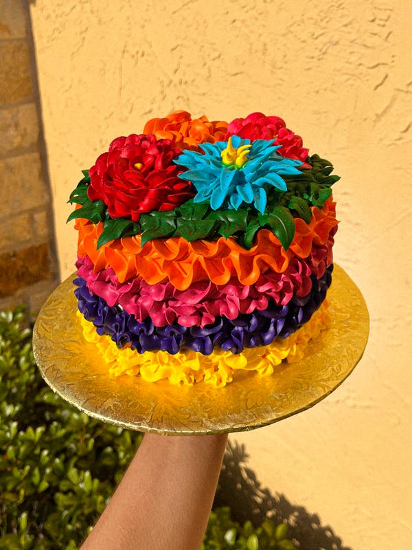 a person holding a birthday cake