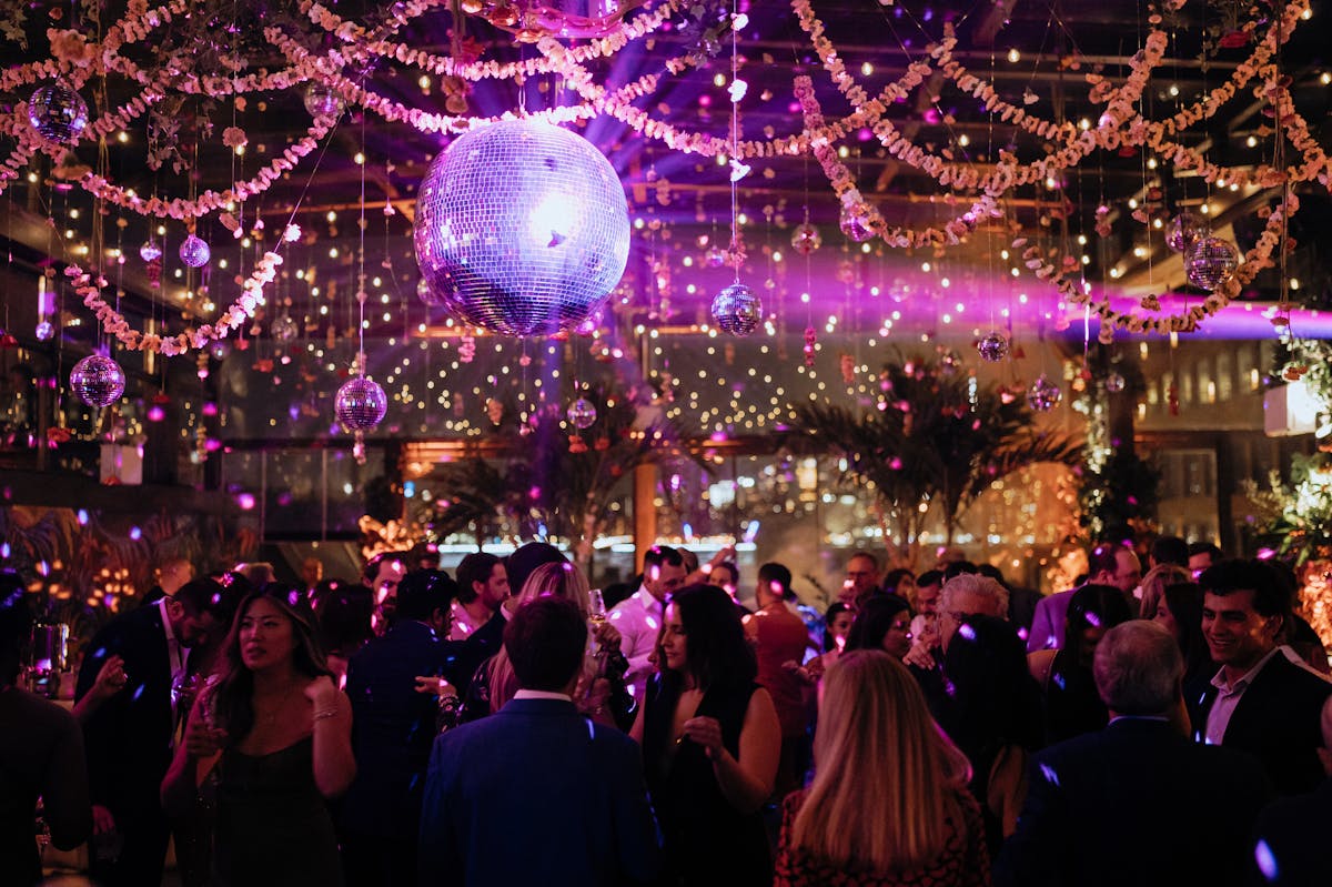 a group of people in front of a large crowd at night