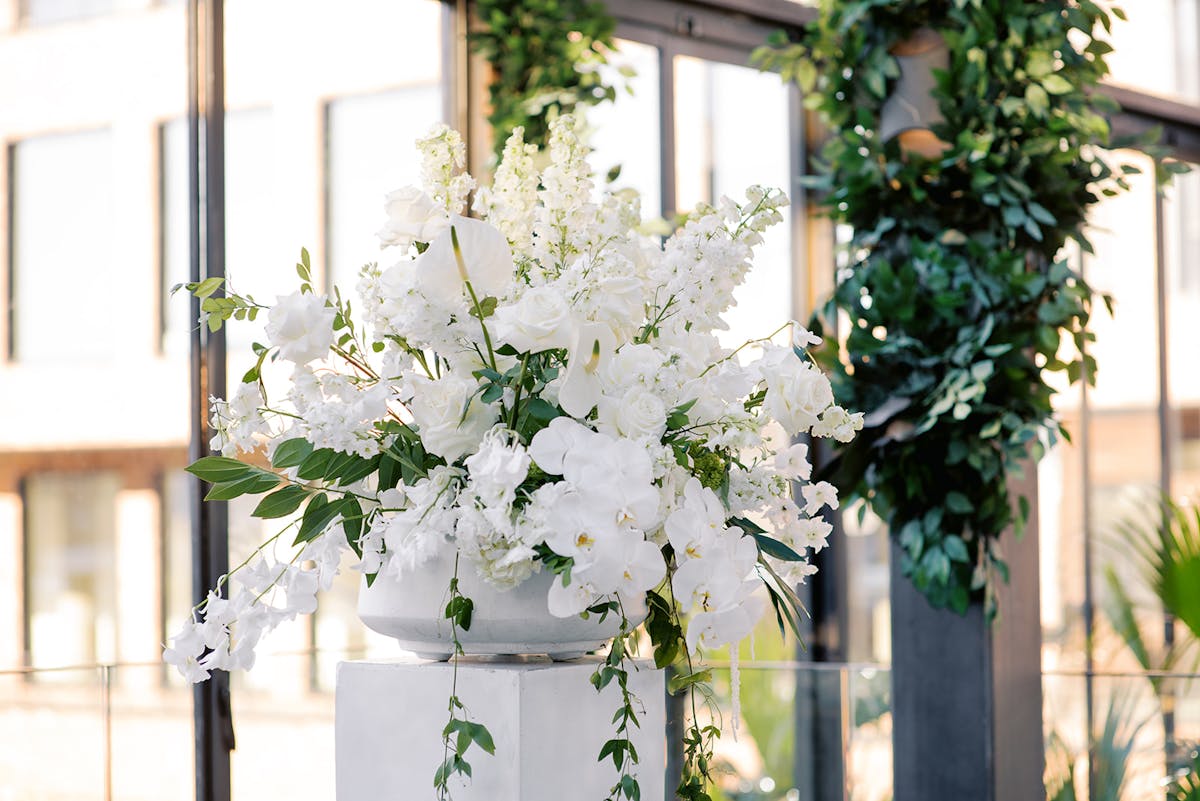 a vase of flowers sits in front of a window