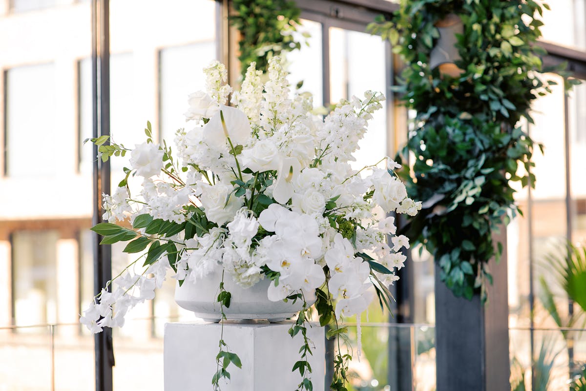 a vase of flowers sits in front of a window
