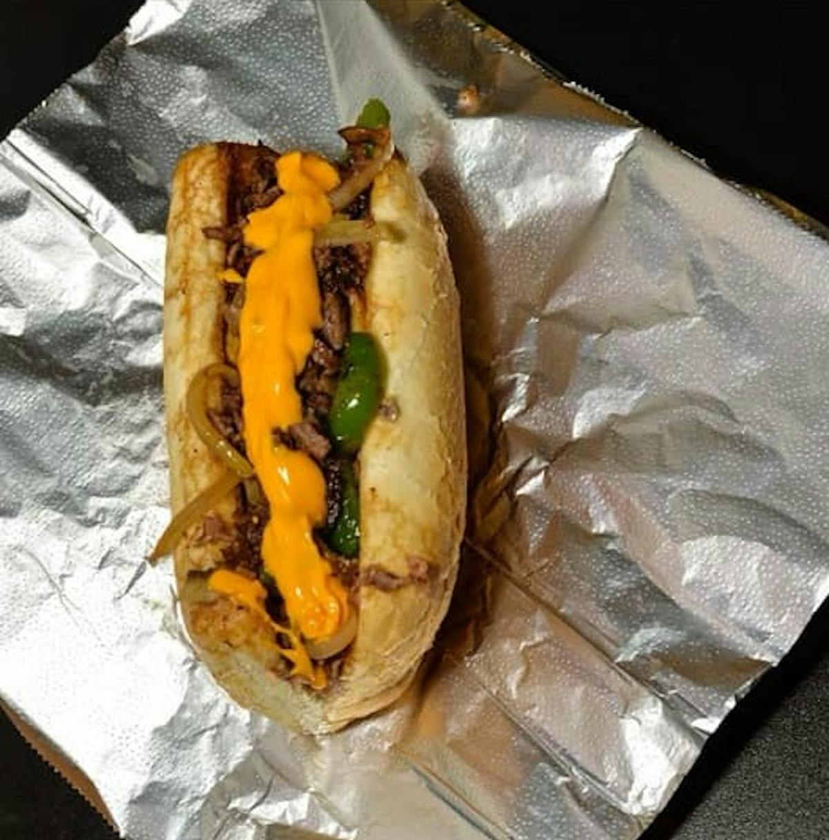 a close up of a hot dog wrapped in a paper bag