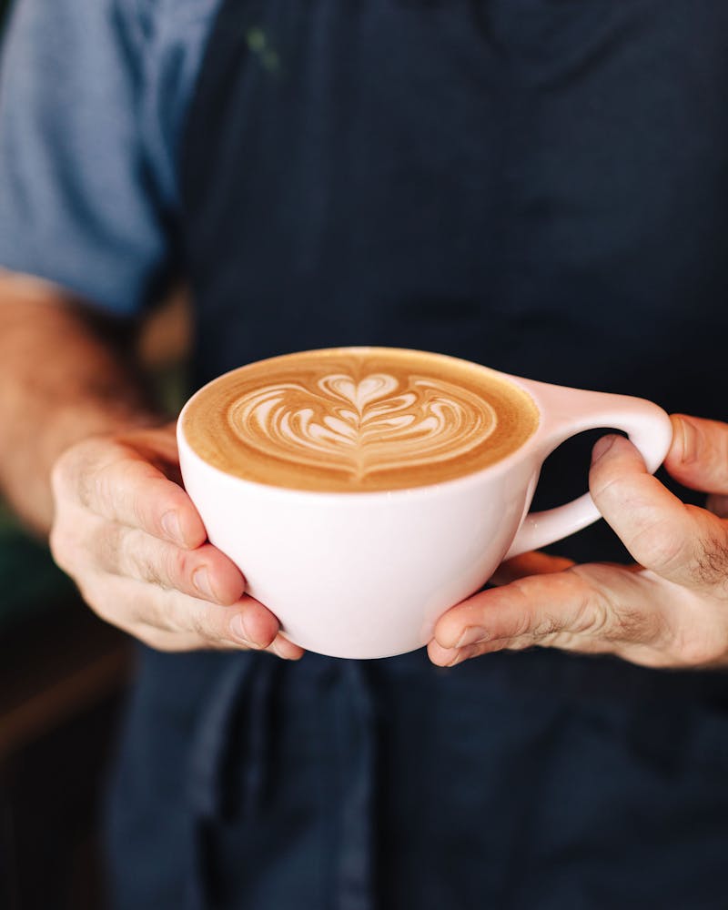 a hand holding a cup of coffee