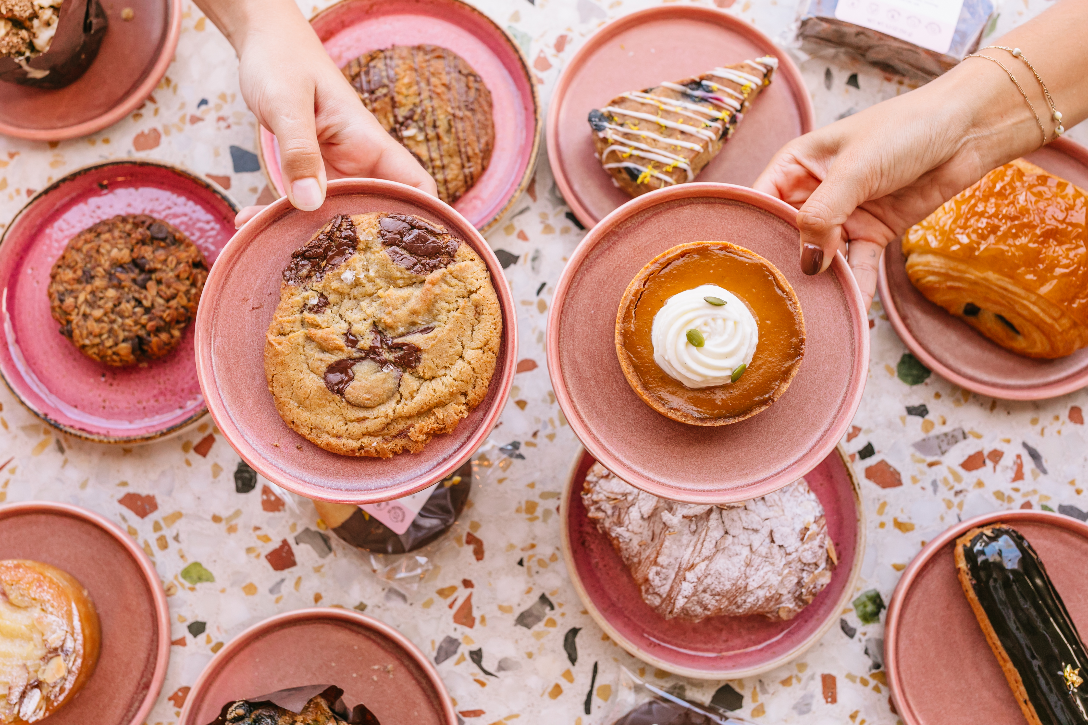 a group of people sitting at a table with a plate of food