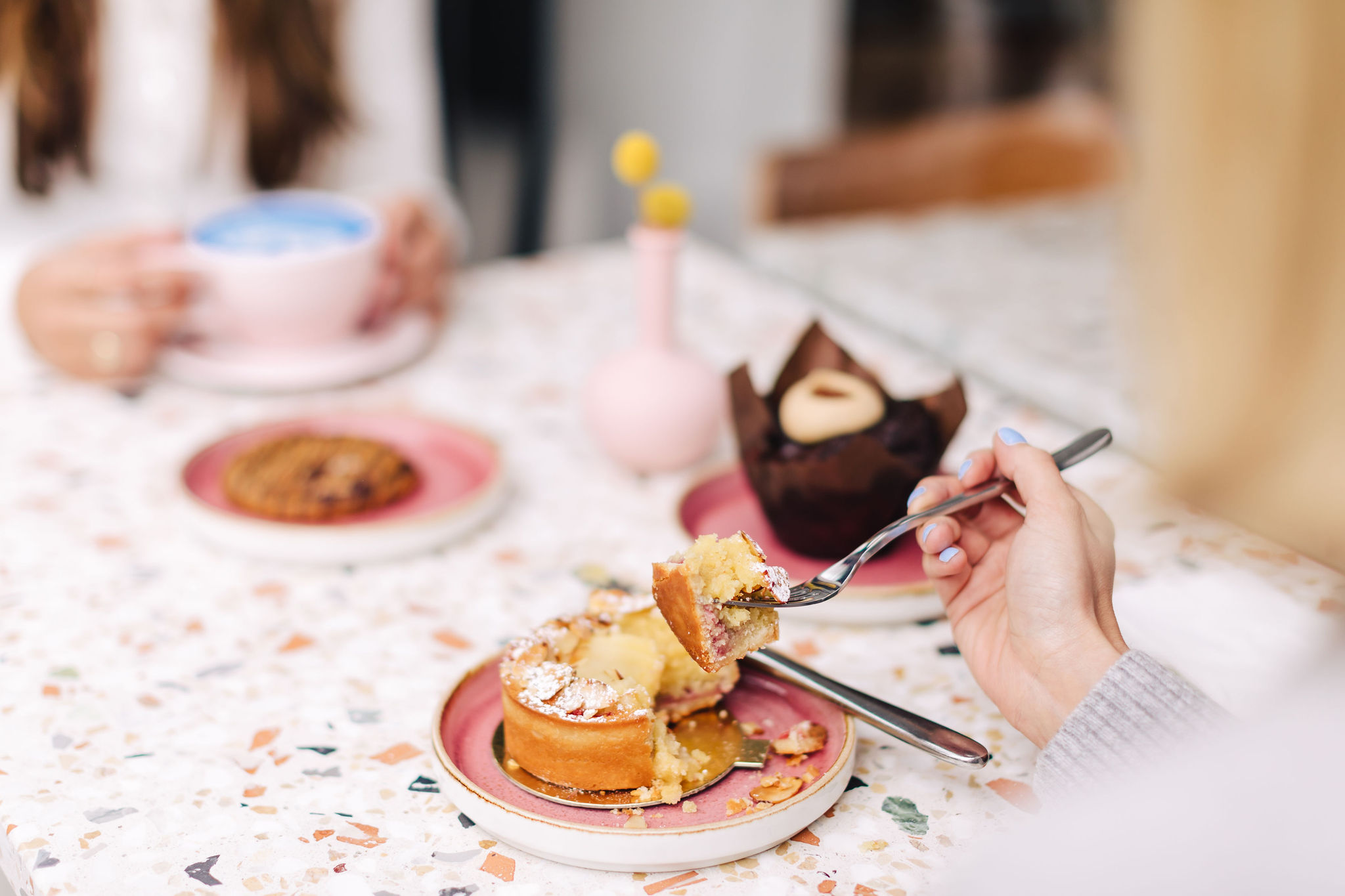 a person sitting at a table with a plate of food