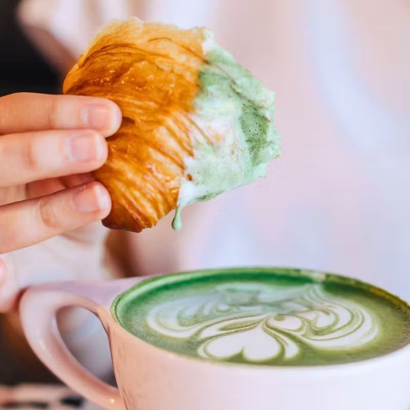 a person holding a cup of coffee