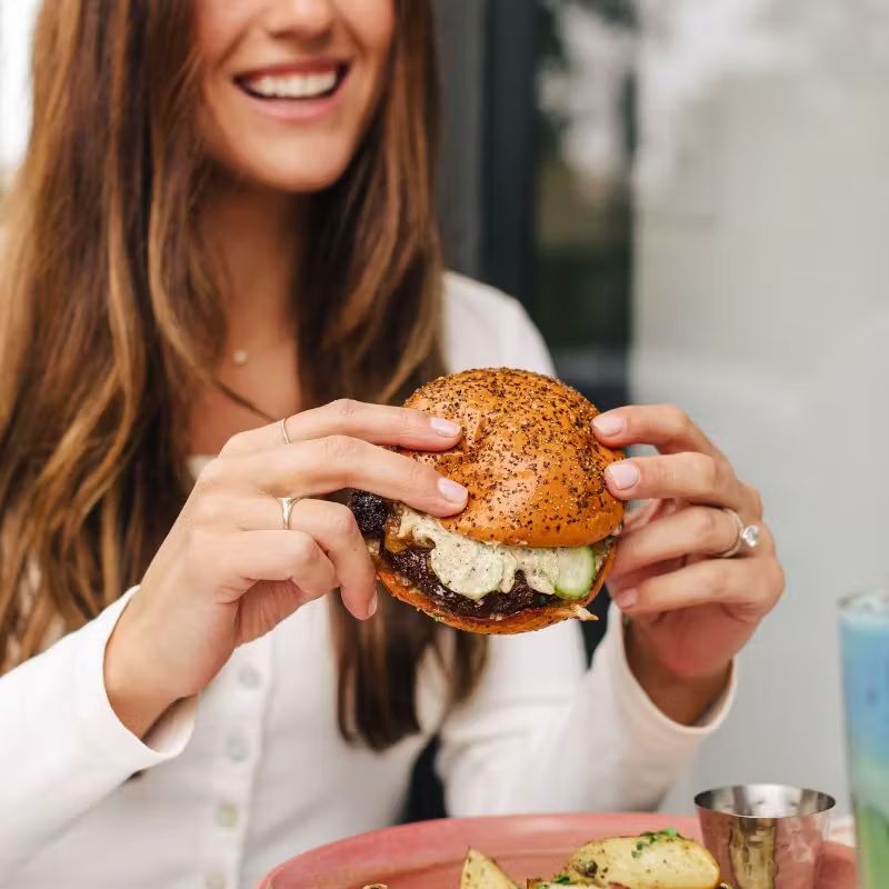 a woman eating a sandwich