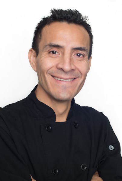a man who is smiling and looking at the camera