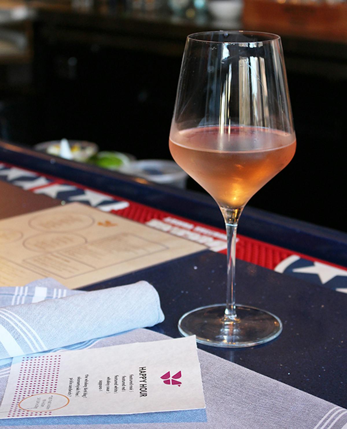 a glass of wine sitting on top of a table