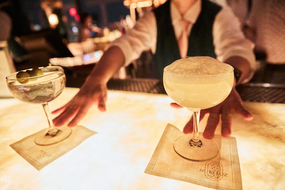 a person holding a piece of cake on a table