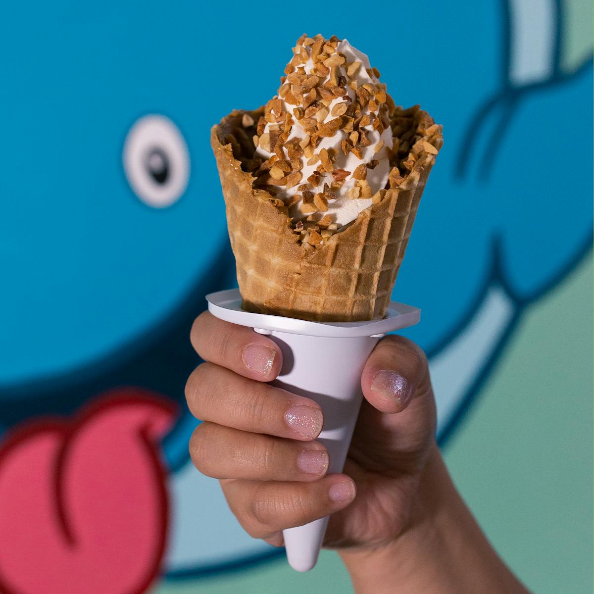 a hand holding an ice cream cone