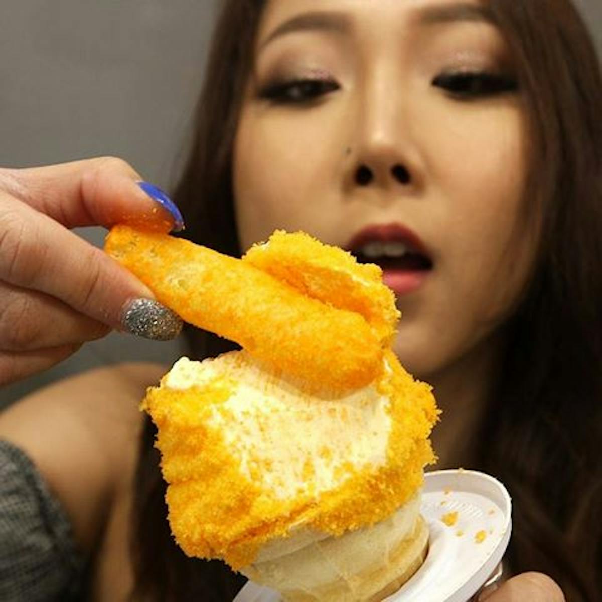 a close up of a girl holding a piece of bread