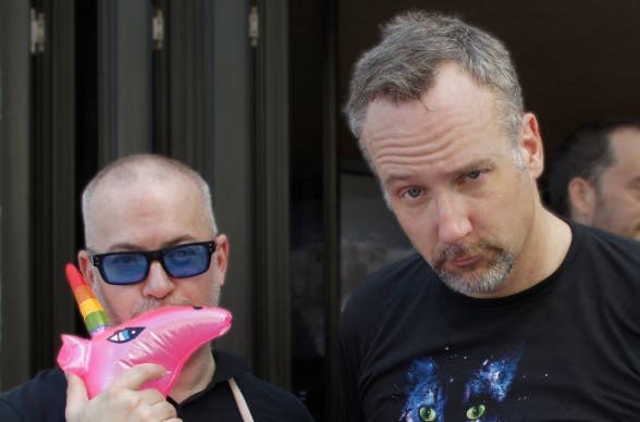 two men posing for the camera