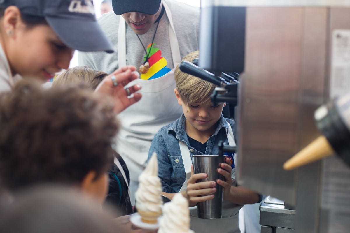 a young boy is preparing food in a kitchen