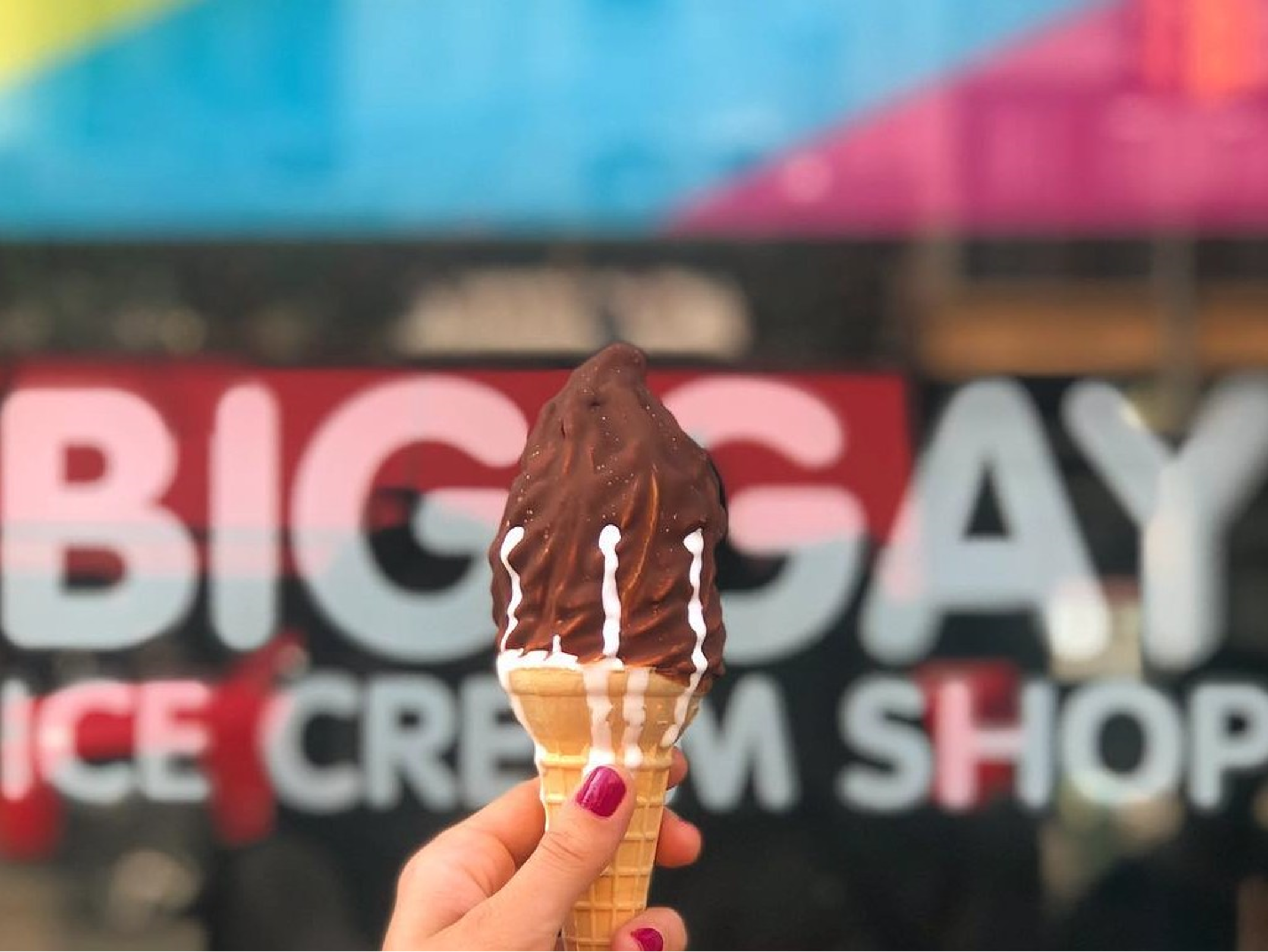 salty pimp soft serve cone dripping being held in front of bgic shop window