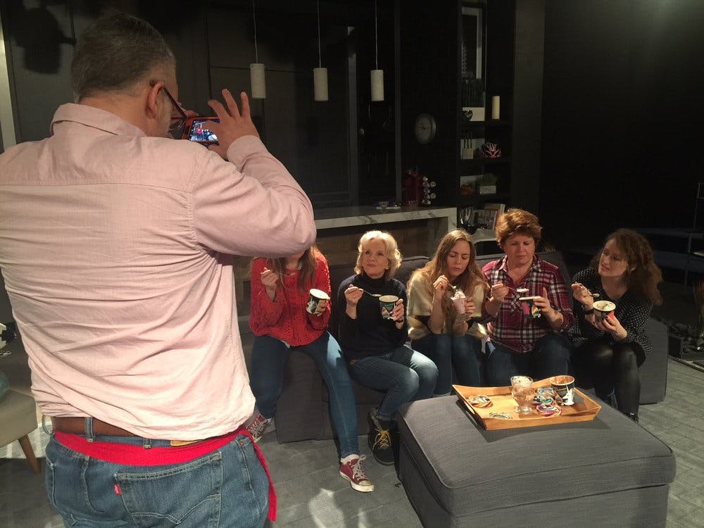 a man taking photos to a group of women