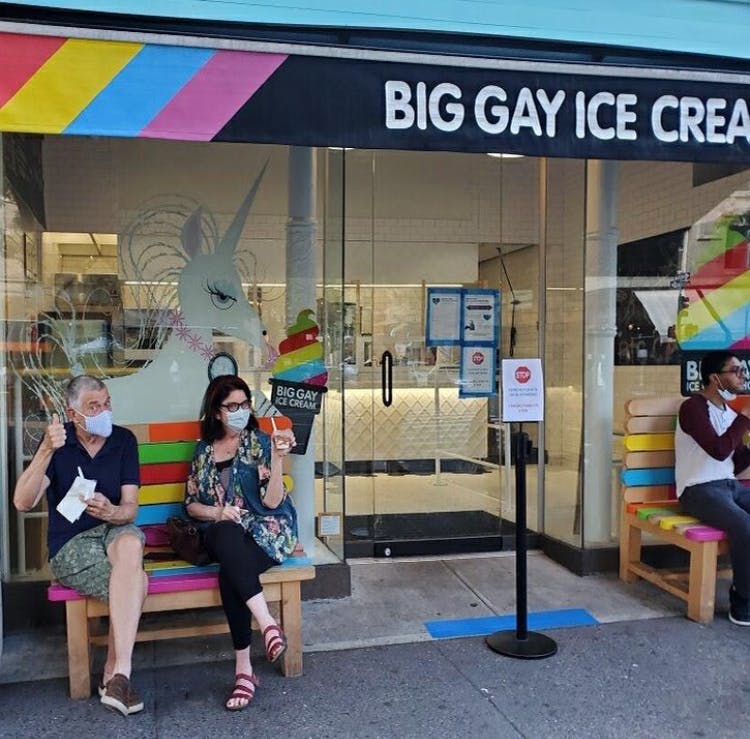a group of people sitting in front of a store