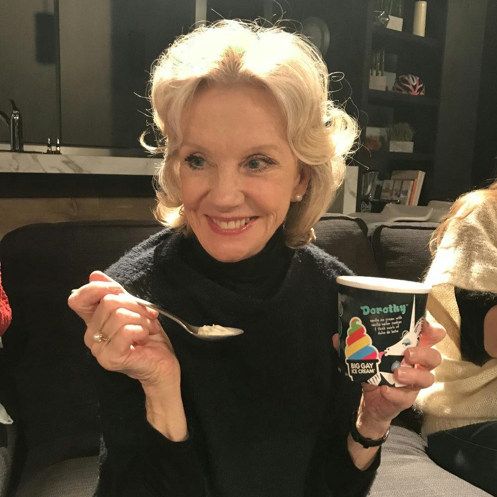 a woman eating ice cream and posing for the camera