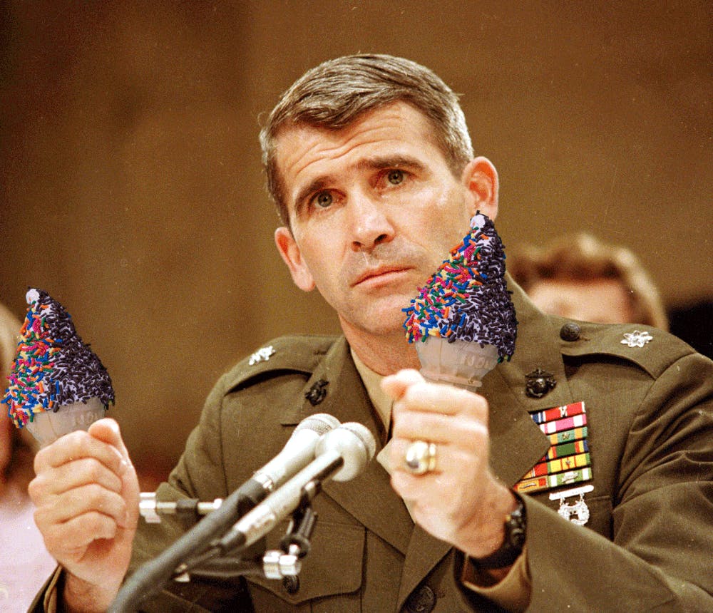 Oliver North holding a microphone