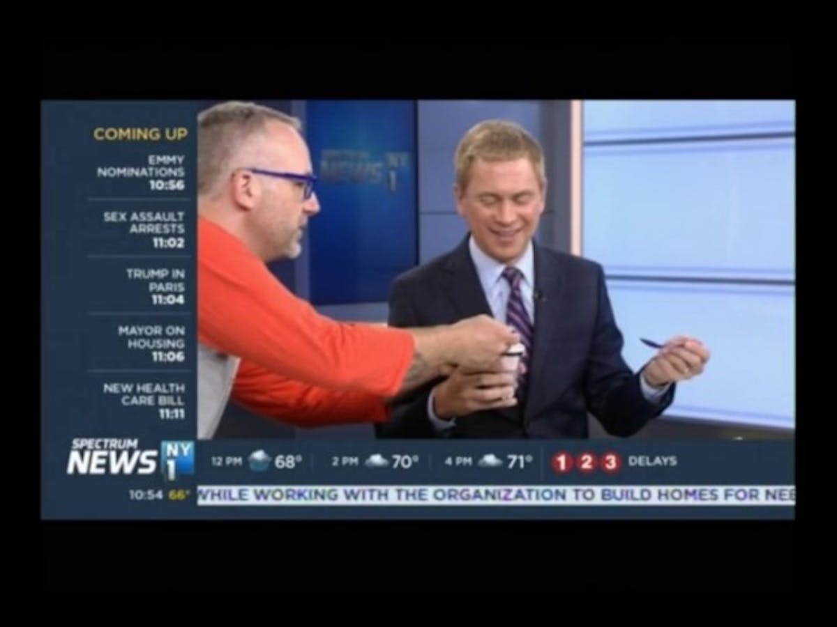 a screenshot of a man eating ice cream on tv