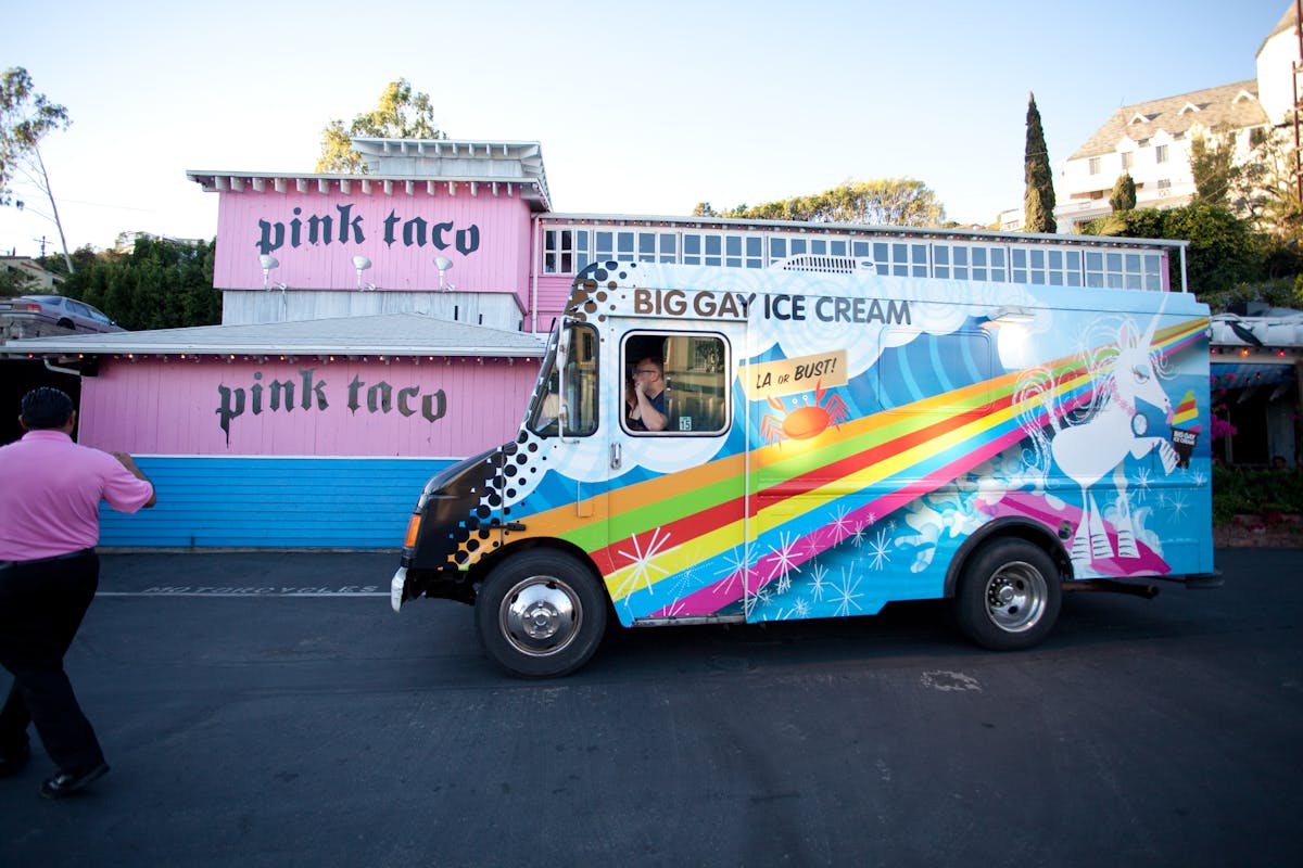 a colorful truck is parked on the side of a building