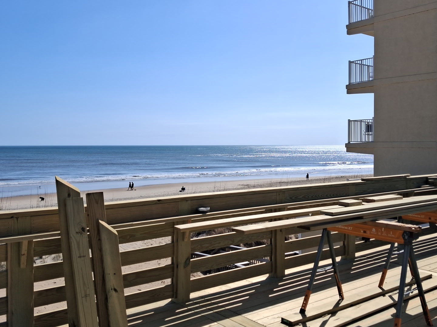 a deck with a beach view