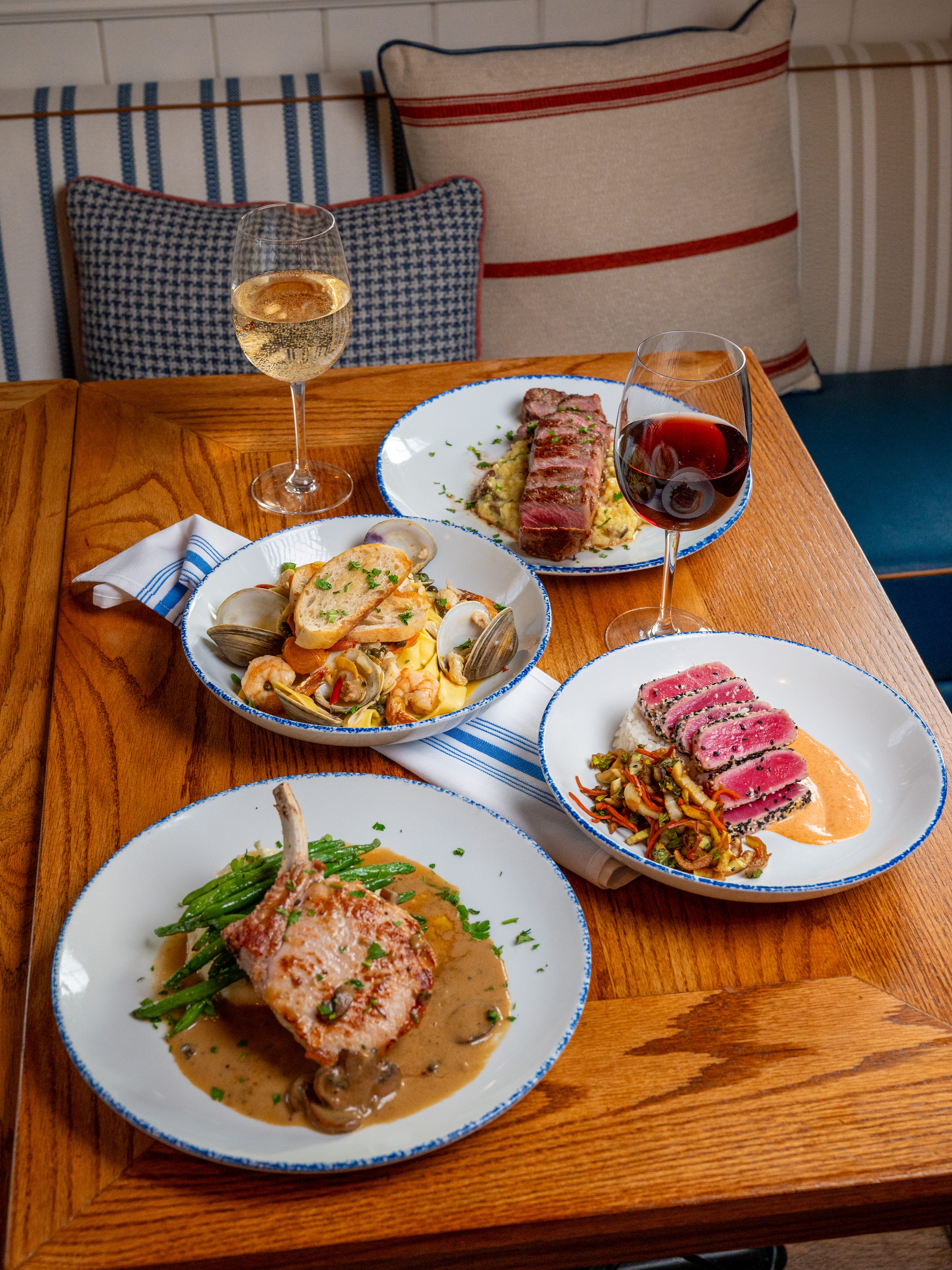 a table with plates of food and wine