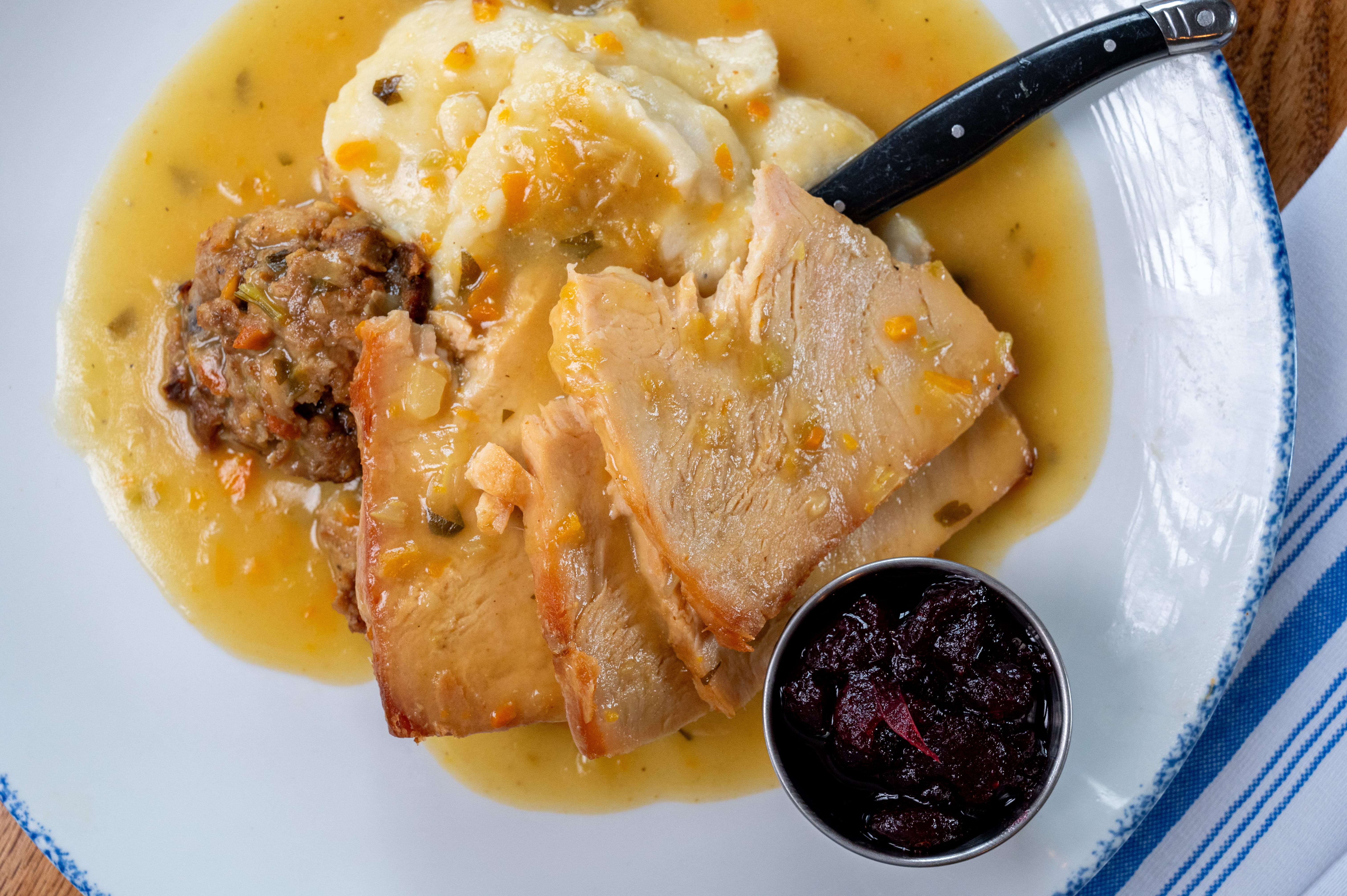 a plate of food with a spoon and sauce