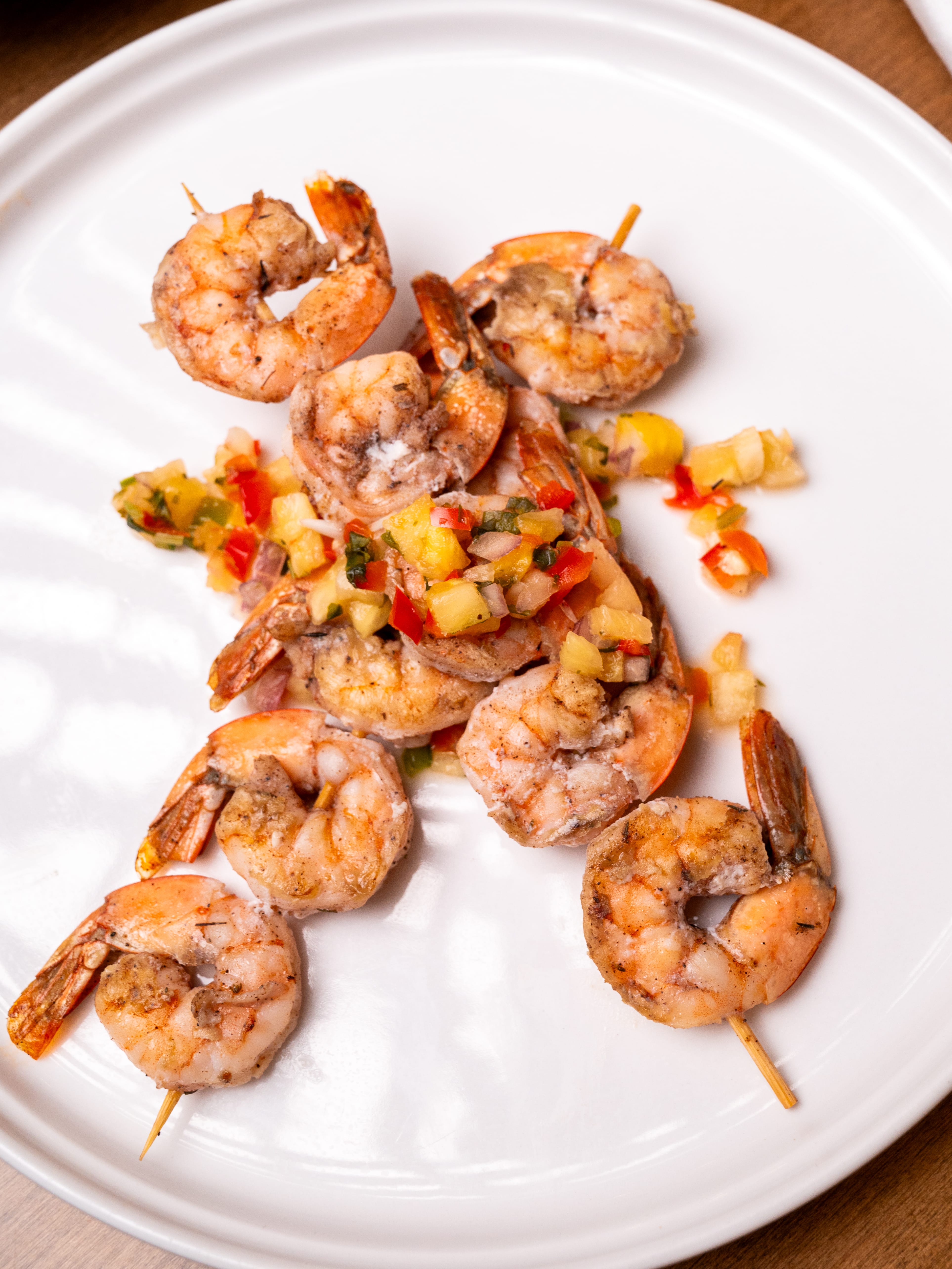 a plate of shrimp on a white surface