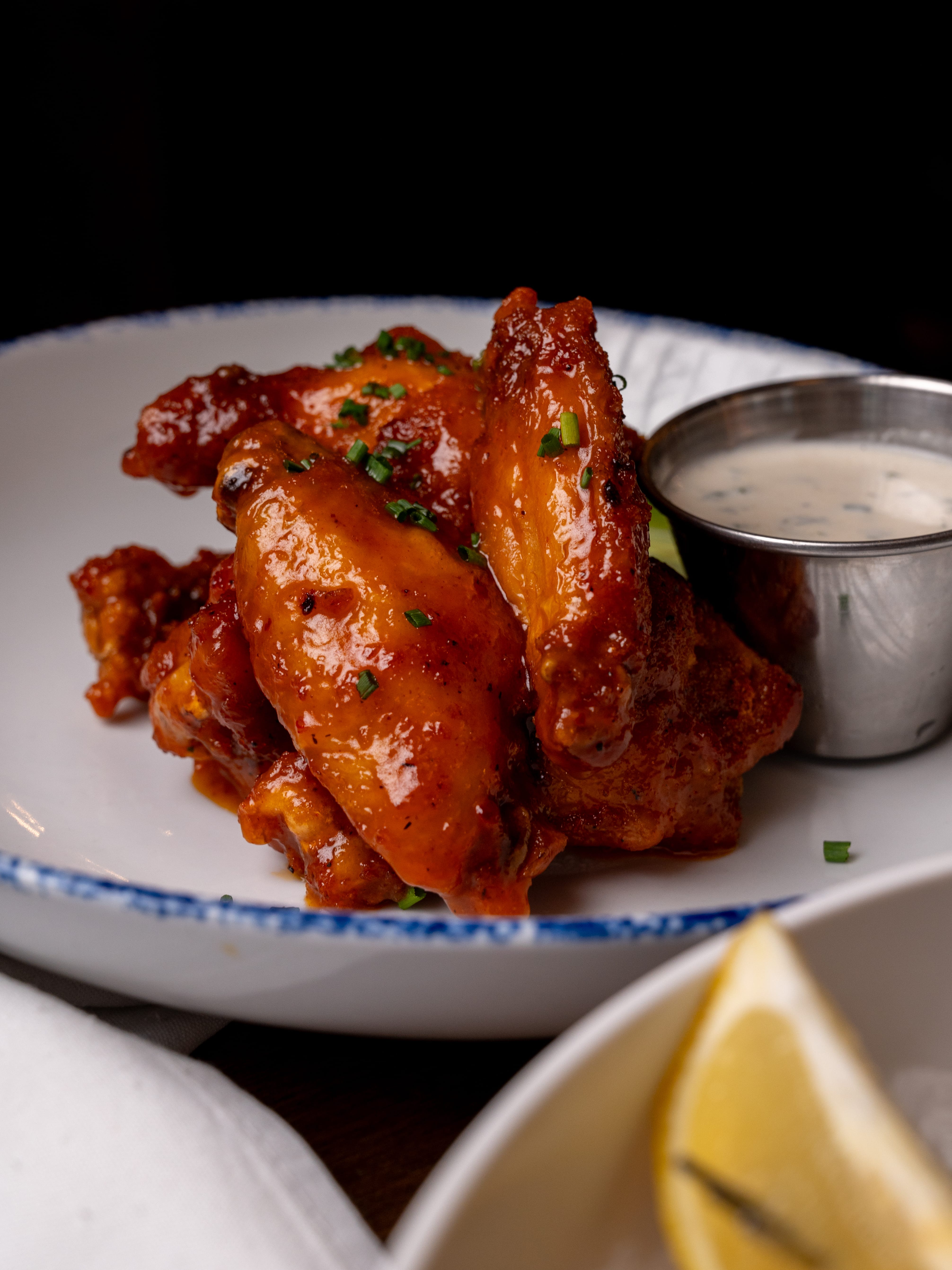 a plate of chicken wings and sauce