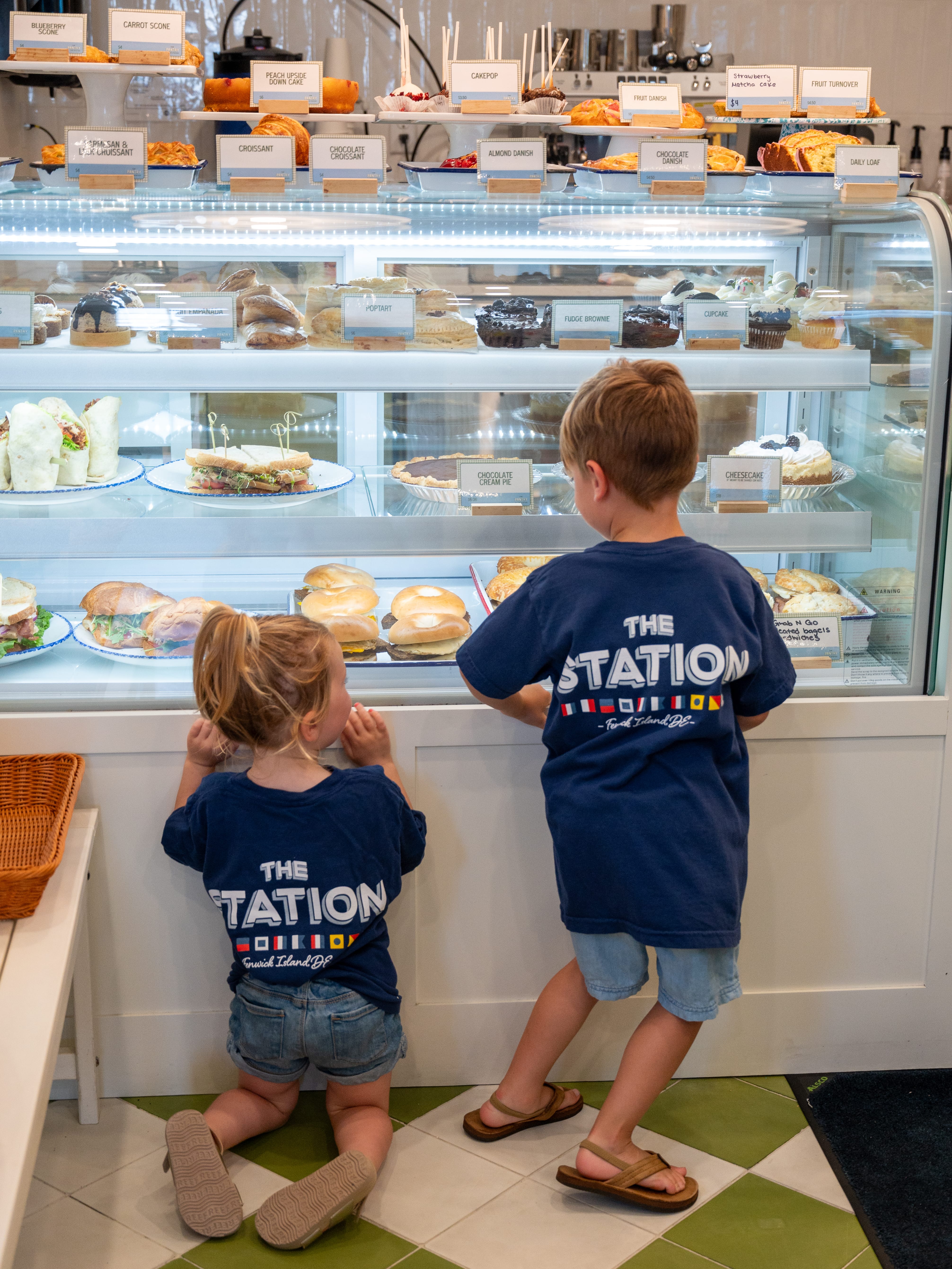 two children looking at a display case