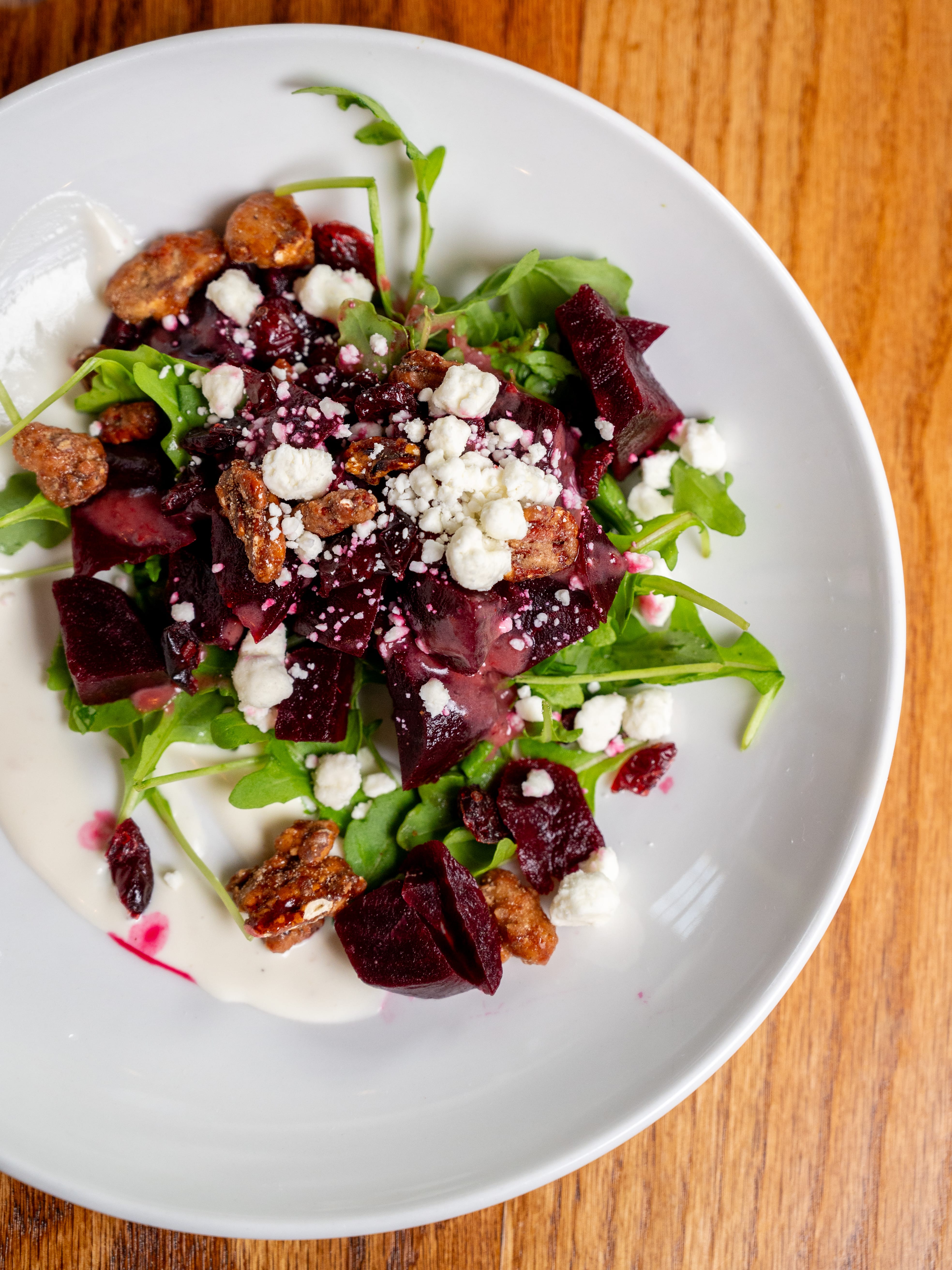 a plate of salad with beets and cheese