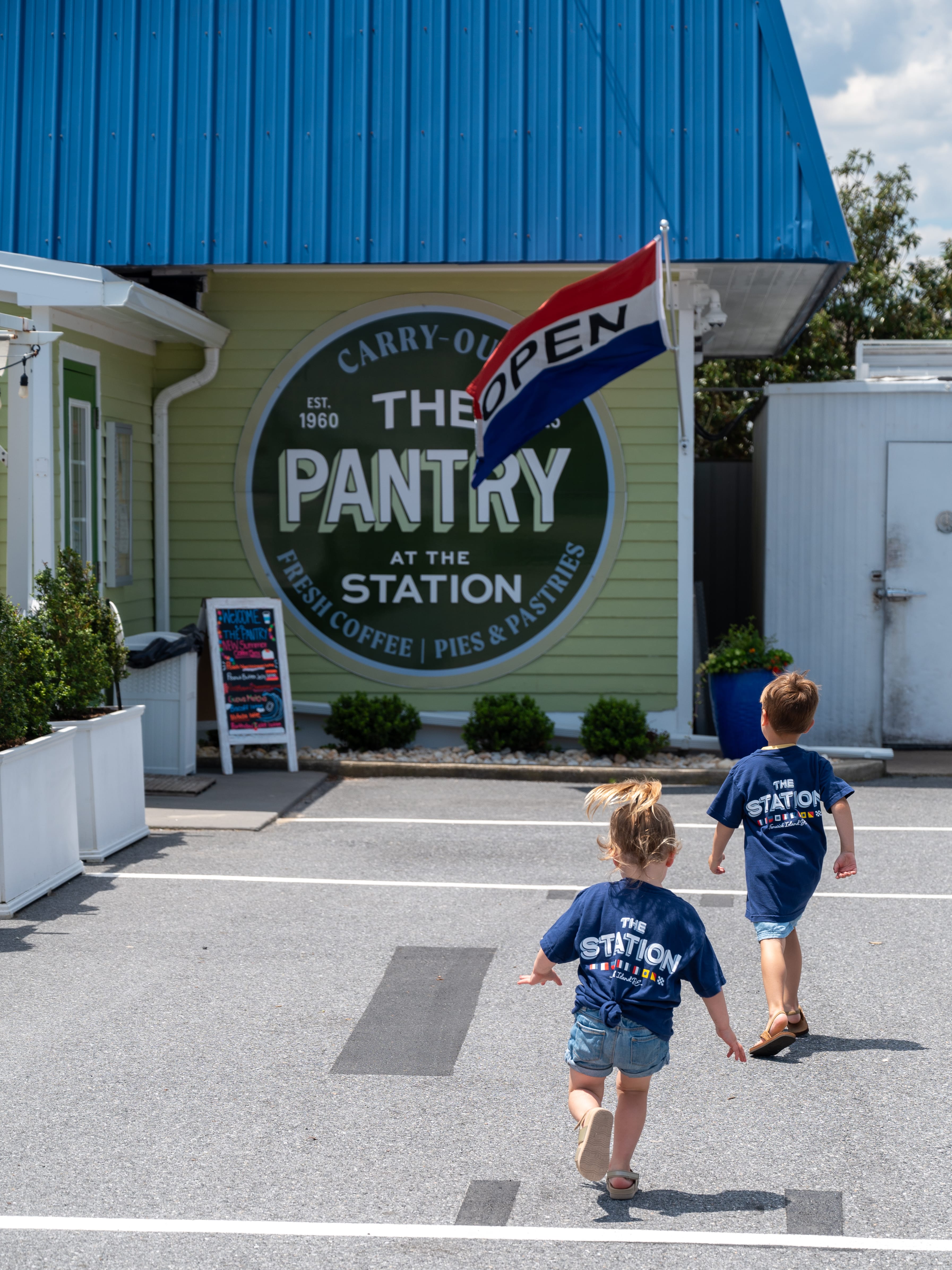 two children walking in a parking lot