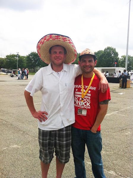 a man wearing a hat posing for the camera