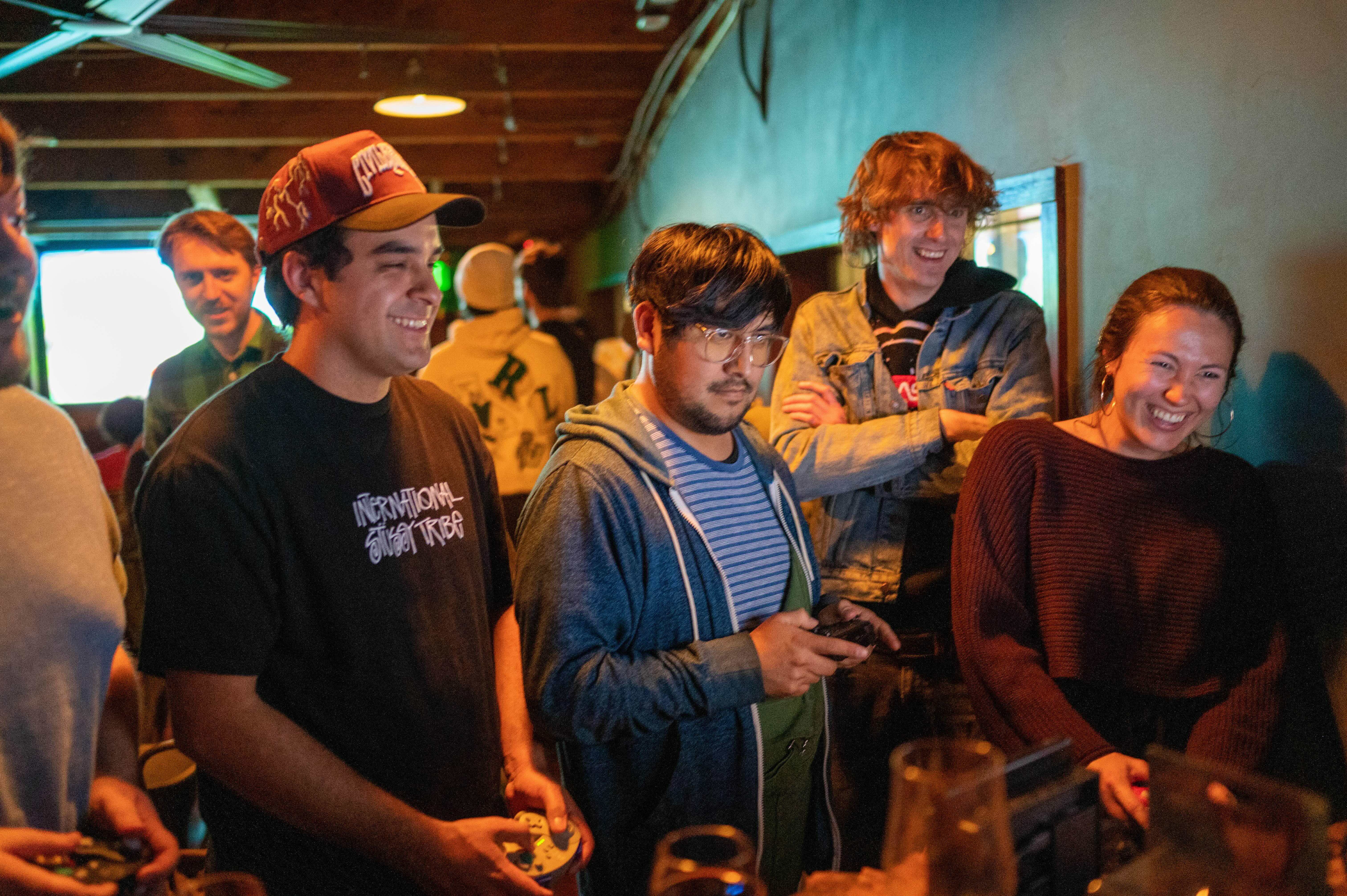 a group of people standing in a room playing video games