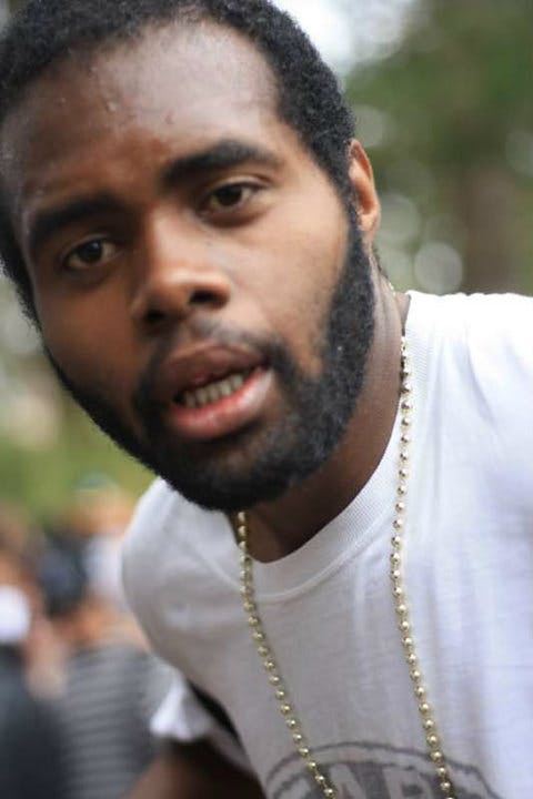 a sweaty, exhausting man at party smiling for the camera