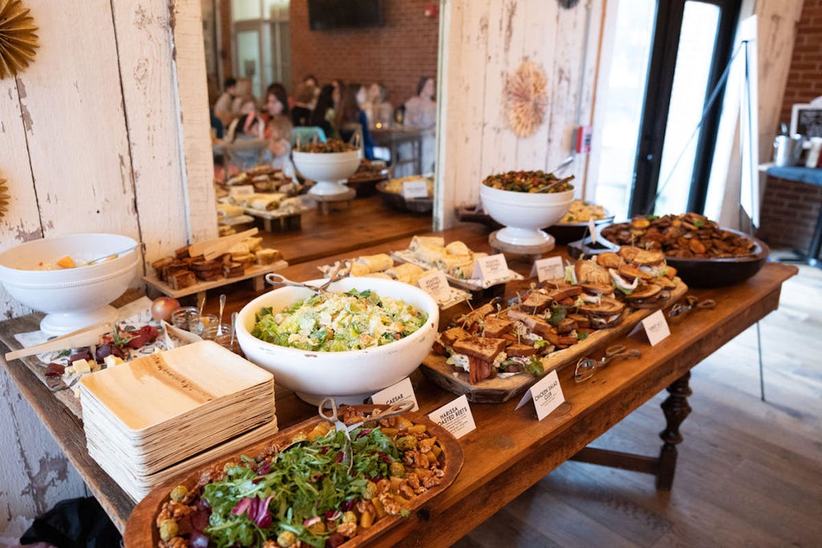 a bowl of food sitting on top of a wooden table