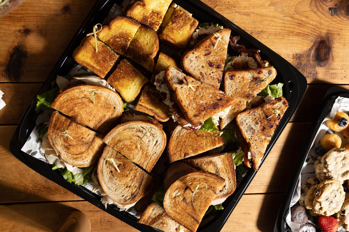 a bunch of food sitting on top of a wooden cutting board