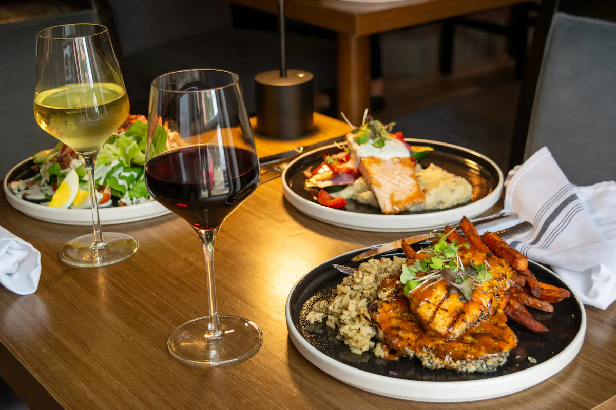 a plate of food and a glass of wine