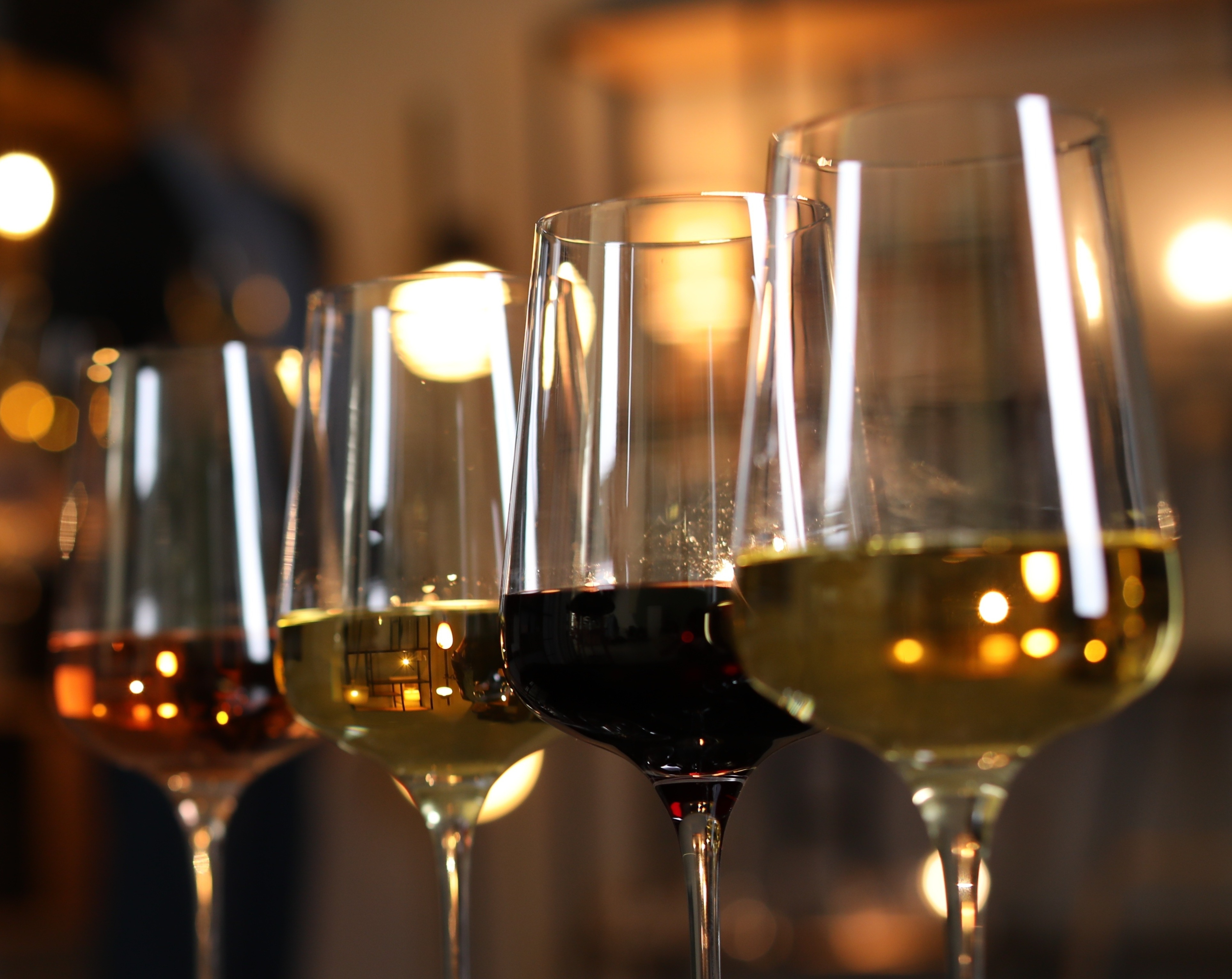 a close up of a four wine glasses