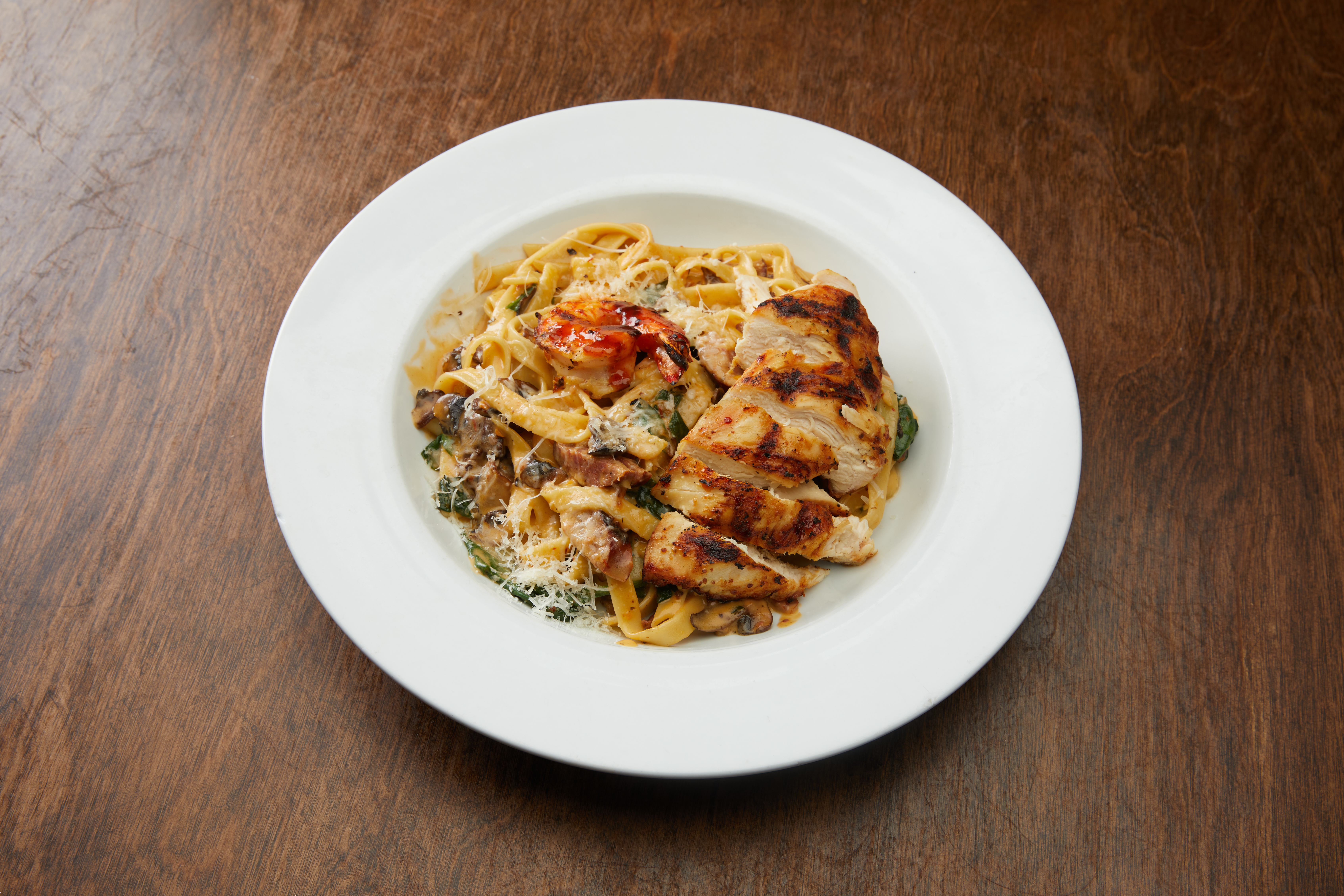 A plate of pasta with chicken and cheese