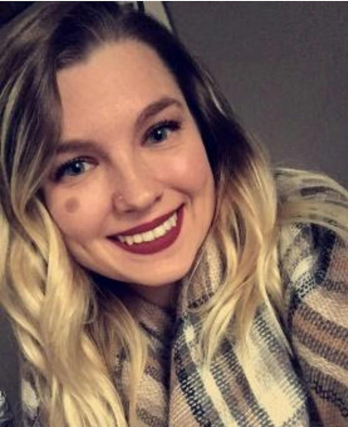 a close up of a girl smiling for the camera