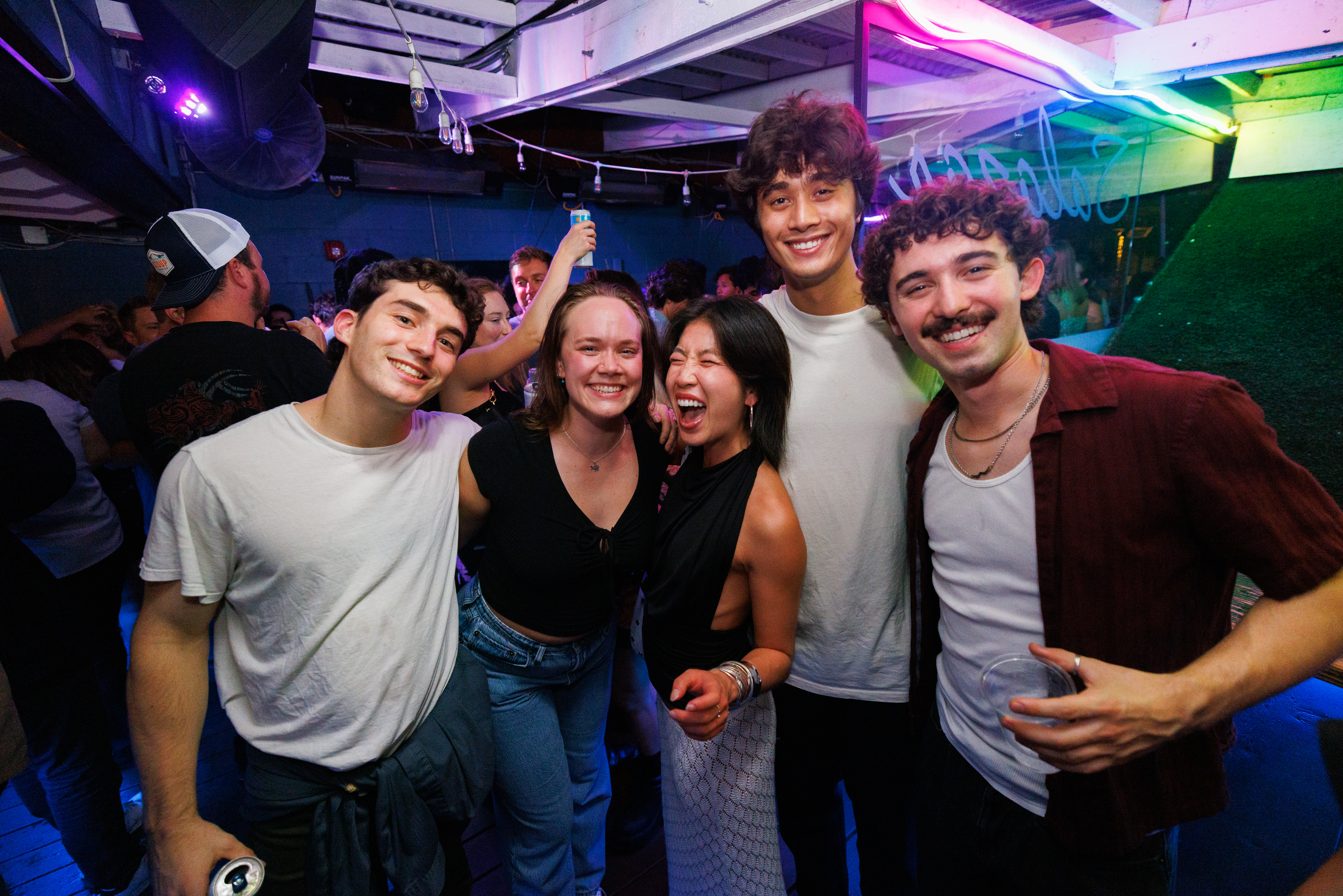 a group of people standing on a stage posing for the camera