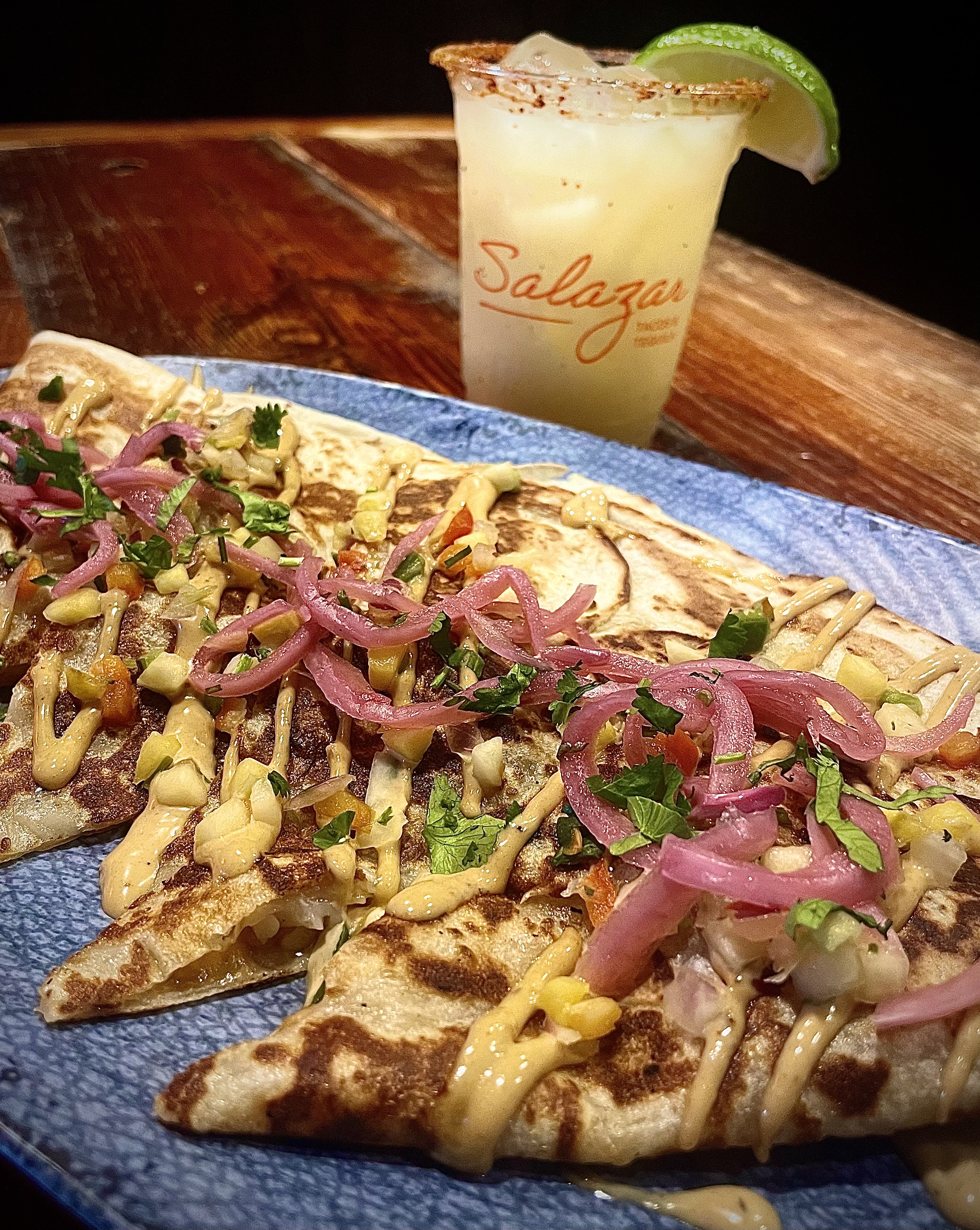 a slice of pizza sitting on top of a wooden table