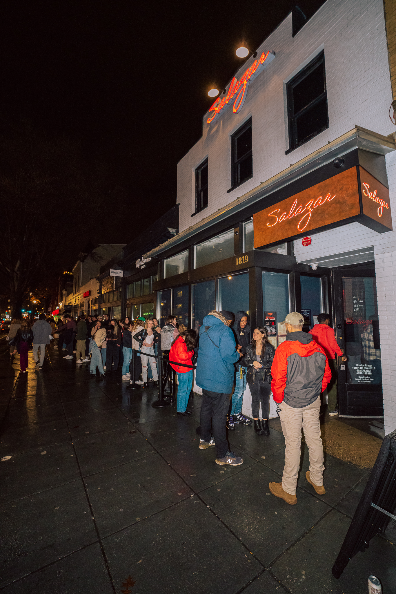 a group of people walking on a sidewalk