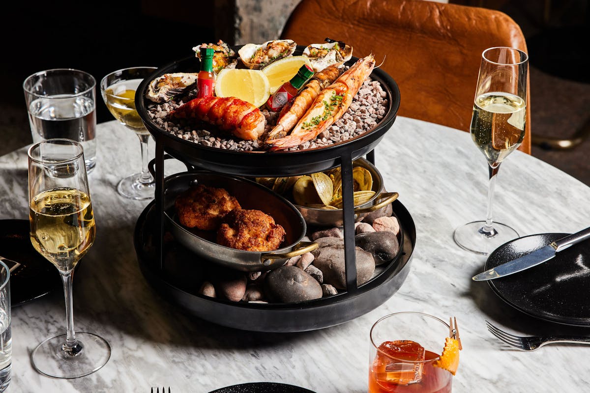 a plate of food and glasses of wine on a table