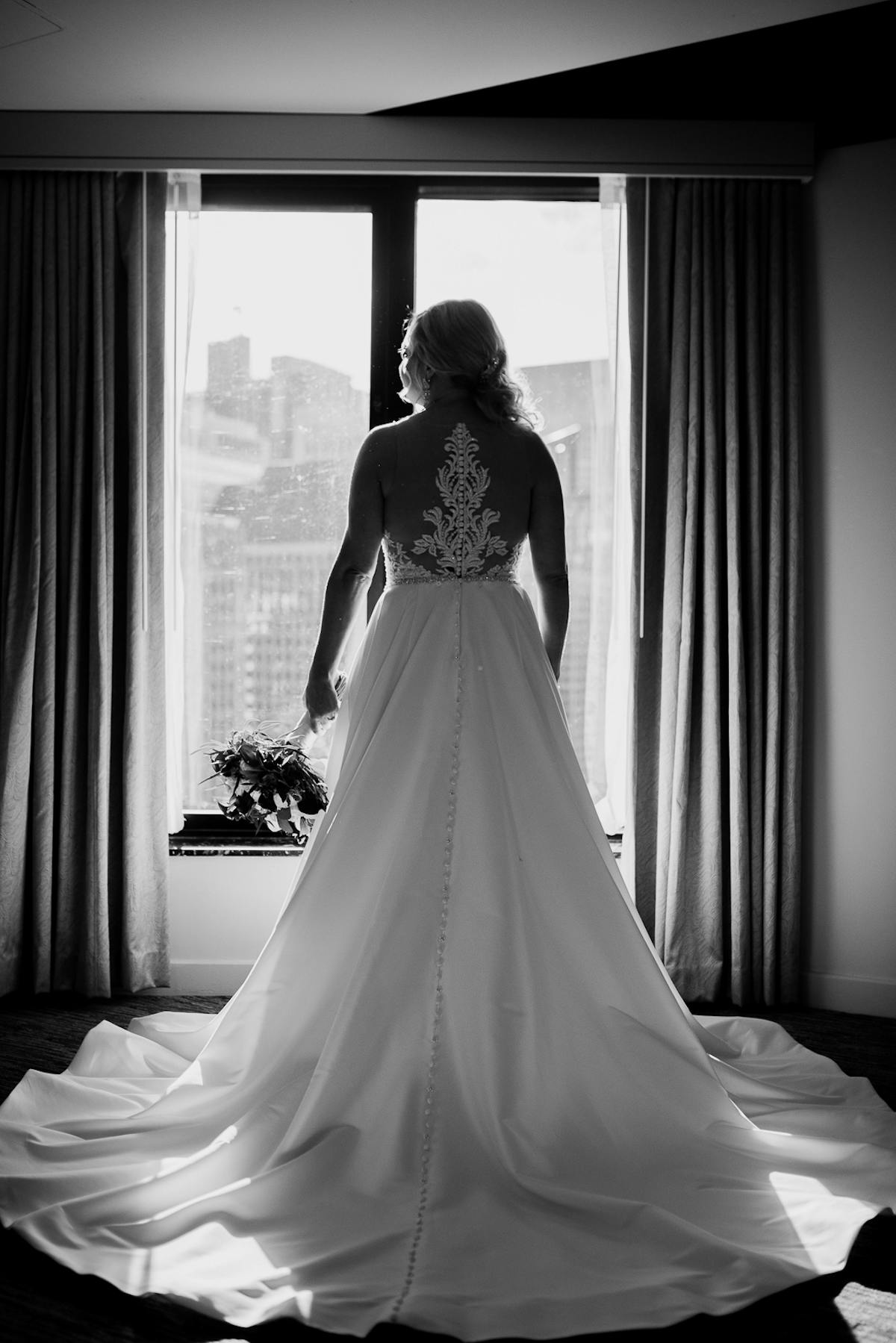 a woman standing in front of a curtain
