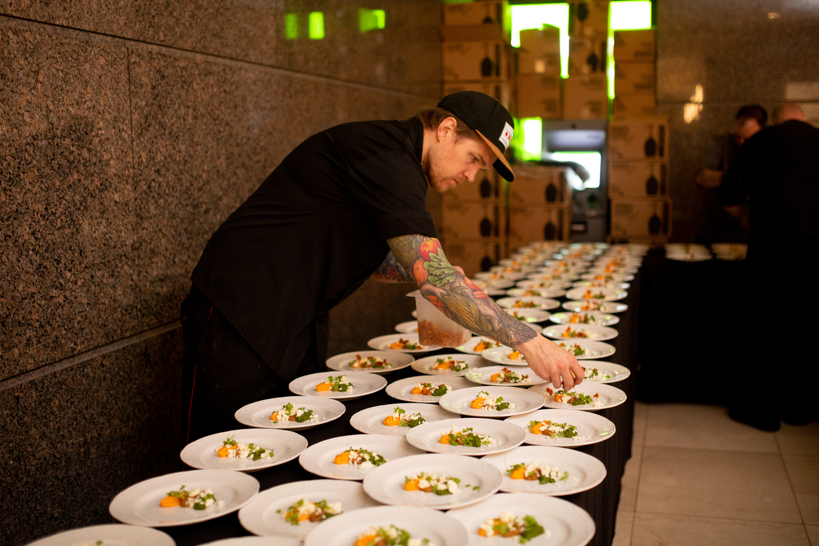 a man sitting at a table with a plate of sushi