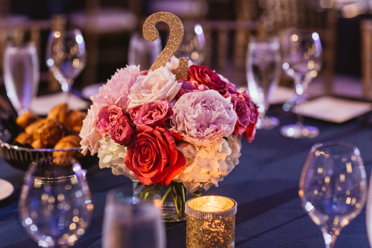 a cake sitting on top of a table with wine glasses
