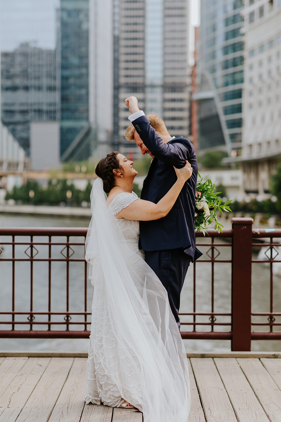 a woman standing in front of a building talking on a cell phone